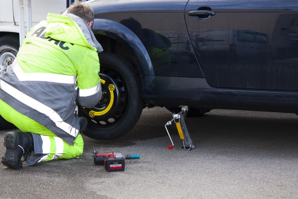 While the vehicle is still lifted, place the spare tire on and loosely secure the lug nuts.